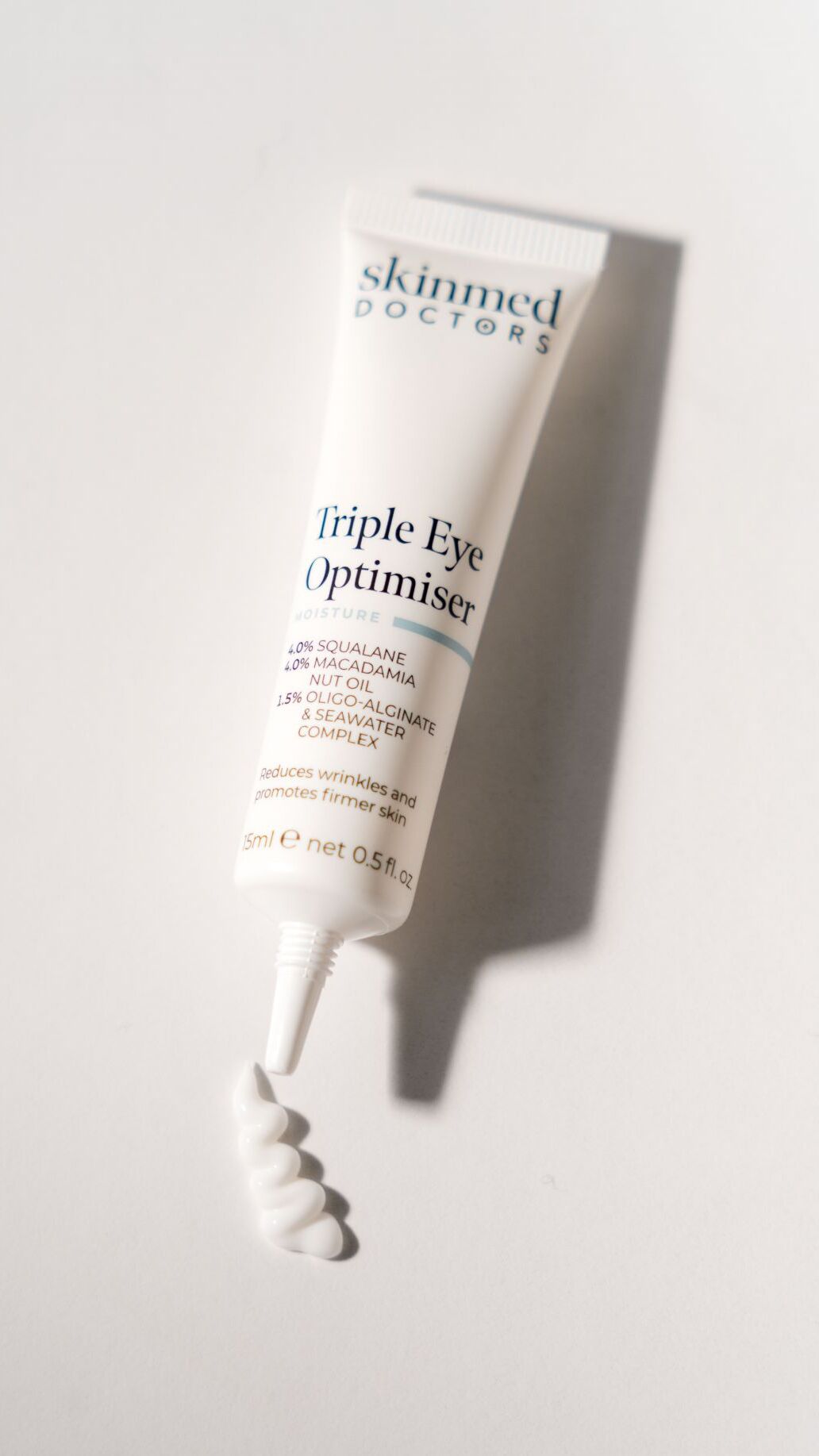 Skinned Doctors Triple Eye Optimiser tube on a white background for daily skin moisture and protection
