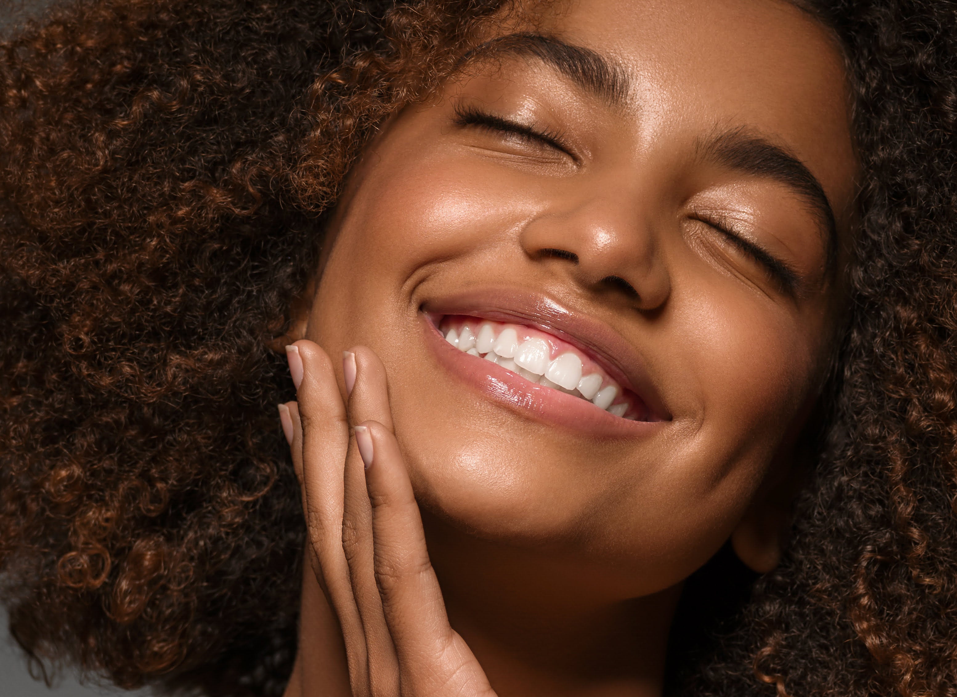 Smiling woman with glowing skin after advanced facial treatment at La Rose Clinic London