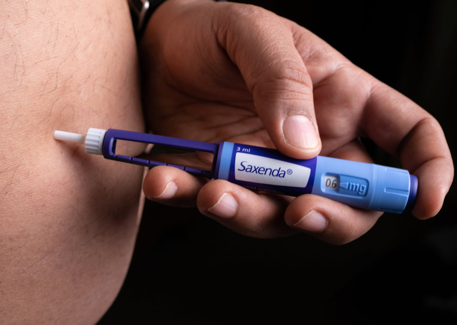 Close-up of Saxenda pen delivering a subcutaneous injection into the abdominal area – visual representation of medical weight loss treatment