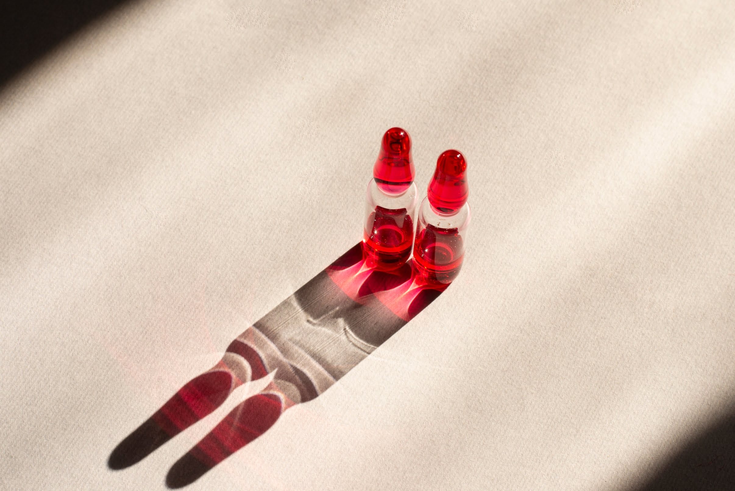 Two glass ampoules labeled Vitamin B12 placed on a clean surface, symbolising injectable treatment for B12 deficiency, energy boost, and neurological support