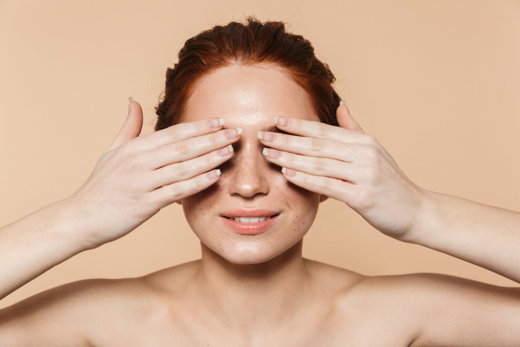 woman covering her eyes with her hands