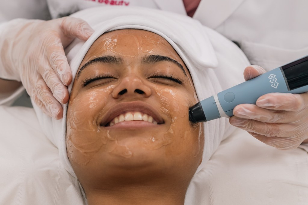 happy woman on rf facial targeted ultrasound